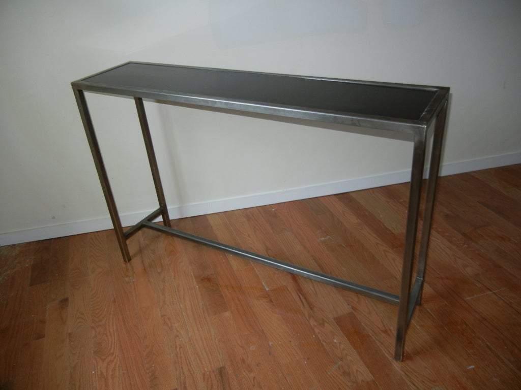 Modern steel and marble console table from Belgium, solid steel structure, with a black marble inset top, perfect for any setting. The depth is 12 inches, great for hallways or tight spots, back of sofas.