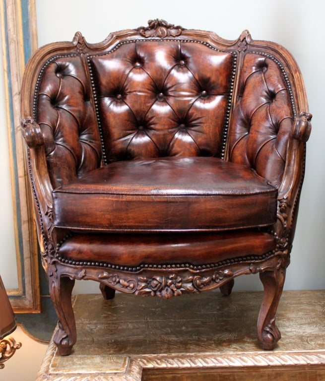 Pair of 19th C. Carved Leather Tufted Armchairs with nail head trim detail.
