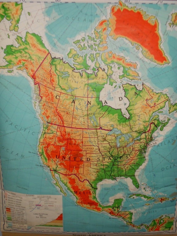 Schoolroom map of North America mounted on retractable wooden roller. The colors are vibrant, the scope is expansive. School may be out for summer but nothing wrong with a little subliminal learning. Hang it in the kids' room and excite their sense