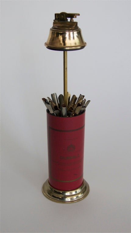 Large red lighter by Dunhill.  The top of the lighter pops up to reveal a 16 cigarette holder.  Great scale, metal base and fully functional.  Incredibly fun piece!