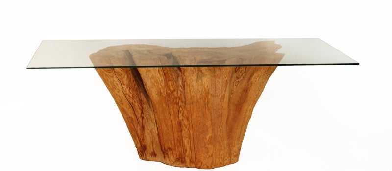 Solid tree trunk console table by Michael Taylor. This piece comes with a new glass top that can be replaced with a thicker and/or larger piece. Measurements of base are: 27