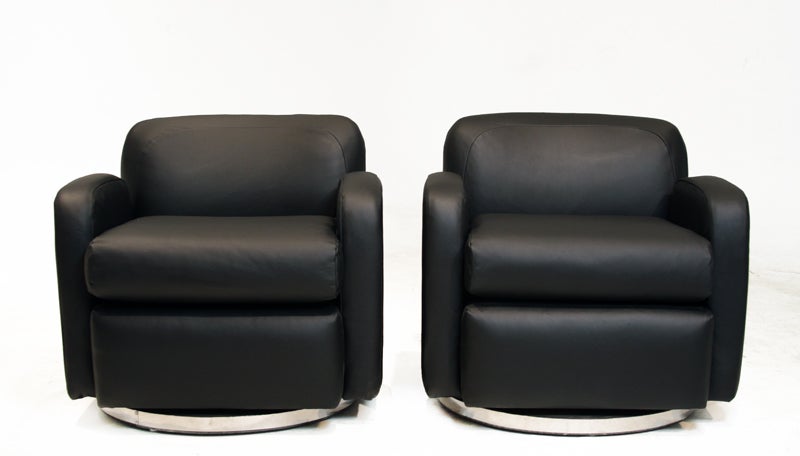 A pair of swivel arm chairs upholstered in a rich black leather with round chrome swivel bases designed by Milo Baughman.
Many pieces are stored in our warehouse, so please give us a call at (323) 463-4434 or email us at info@thomashayesgallery.com