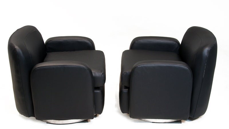 Mid-20th Century Pair of petite lack leather swivel arm chairs by Milo Baughman