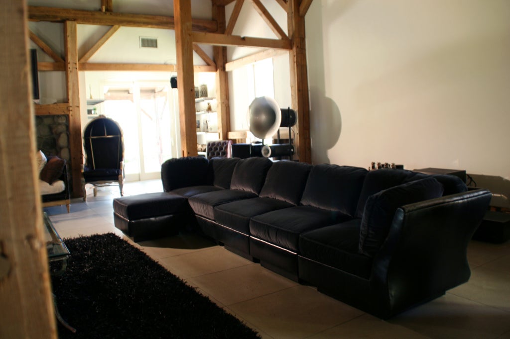 Beautiful modular sectional with ottoman, designed by Pierre Cardin, c. 1970s. Consists of 6 pieces/sections total, can be arranged to any length you'd like. Newly reupholstered frame/body in soft Italian black leather. New seat & back cushions,