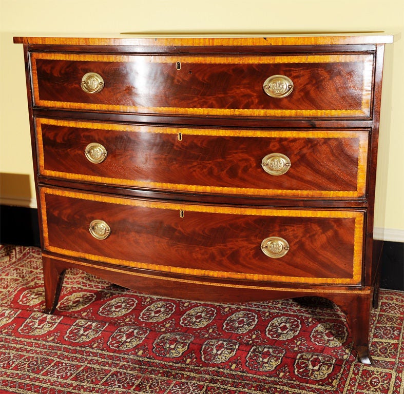 Hepplewhite chest of diminutive height. French feet. Shaped skirt