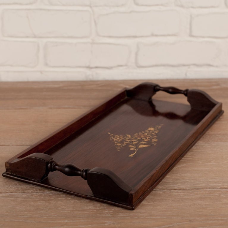 Solid rosewood tray with ivory inlay center foliate pattern and turned wood handles.
