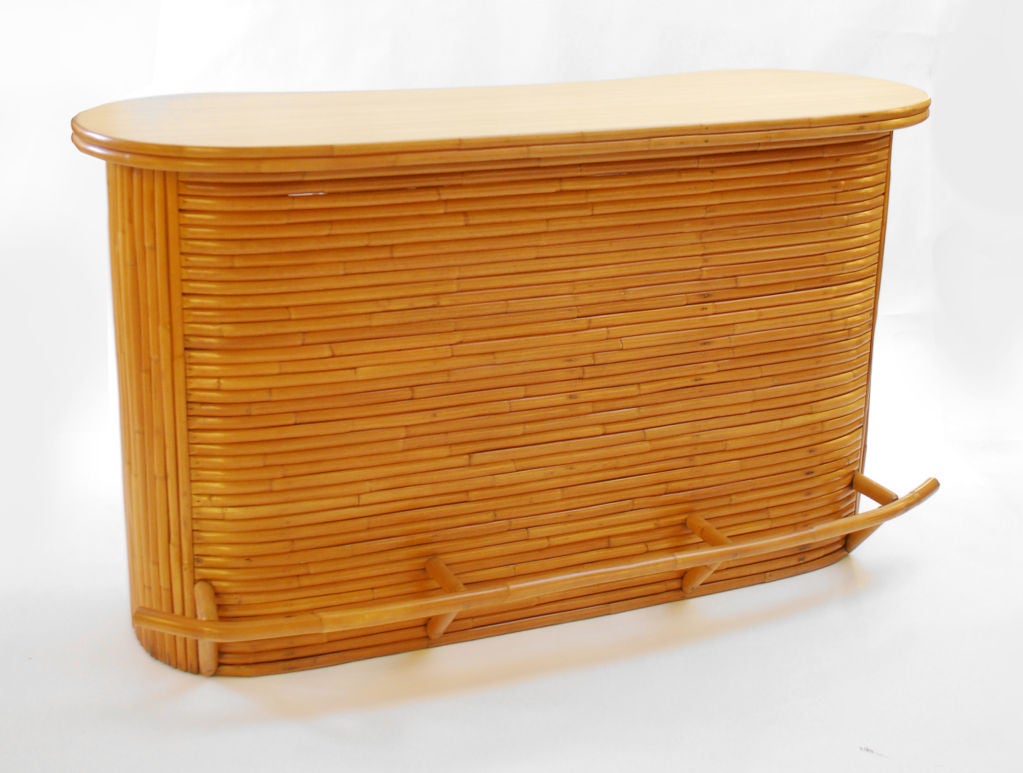 Fine & rare large scale stacked rattan bar with storage, shelves, foot rest, and cutting board.***Contact/Shipping Information: AOL (American Online) users may experience difficulties sending emails to us or receiving emails from us. If you have