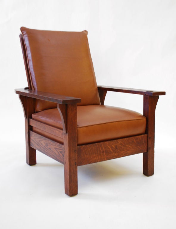 Fine, adjustable morris lounge chair by L & JG Stickley. Flat-arm form with corbel supports, pegging, and thru-tenons. Model #470.