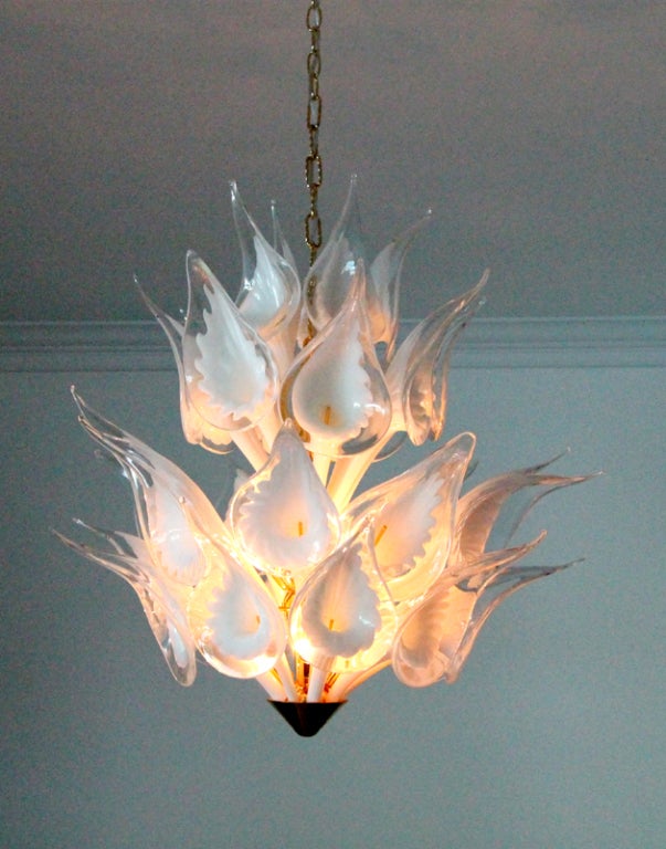 An elegant art glass hanging light fixture by Camer, Murano Italy. Four tiers blown glass of Lily petals surround a central brass center fitting and radiates a beautiful illumination.