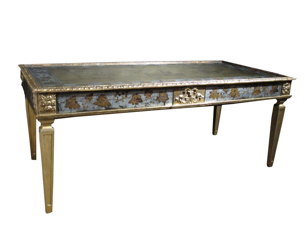 Silver eglomise neoclassical coffee table stamped Jansen.  Maison Jansen was a Paris-based interior decoration office founded in 1880 by Dutch-born Jean-Henri Jansen . Jansen is considered the first truly global design firm, serving clients in