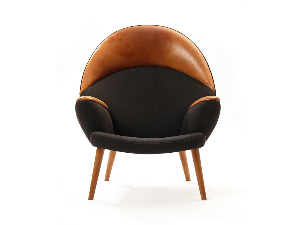 A rare Upholstered Peacock Lounge Chair with the original charcoal wool Savak body, natural leather head and armrests on tapered oak legs. Model JH-521.