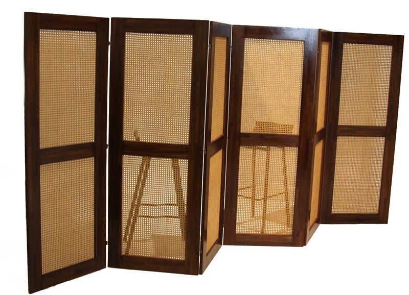 Massive Danish screen or room divider with six panels of caning, solid staved teak frames and brass hardware. When sitting straight the screen spans 12 feet.

