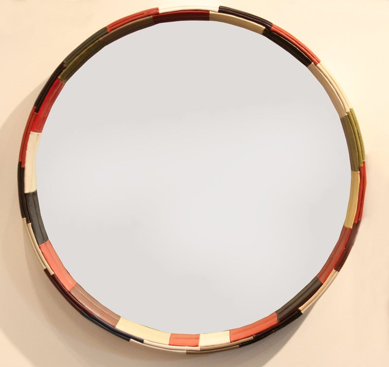 Large beautiful circular mirror spanning 3 feet by Thomas Hayes Studio. The frame has been wrapped in a patchwork leather with piping along the front edge.

Available for custom order and the lead time is 6-8 weeks; sometimes we are able to