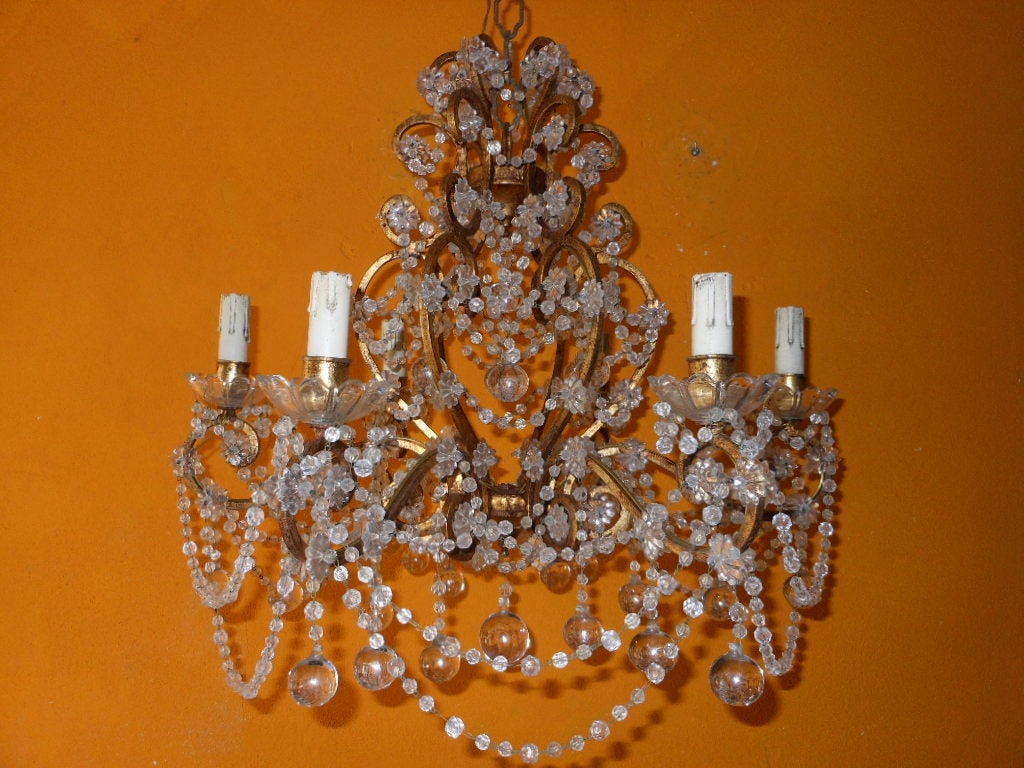 Stunning French crystal heavy beaded chandelier.Gold gilded body,beaded swags,crystal stars and balls.Crystal bobeches housing 6 lights everything original just gorgeous!!!
