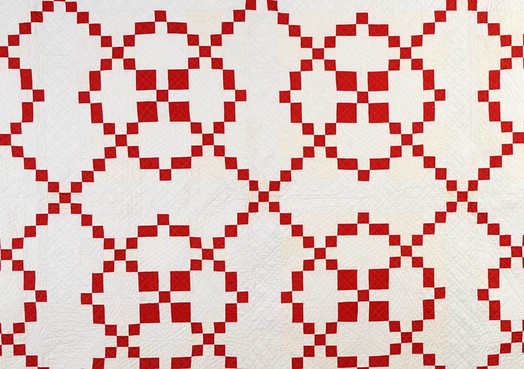 This classic Burgoyne Surrounded quilt pattern is enhanced by a wonderful checkerboard border. The squares used throughout the quilt are continued to create the border and Sixteen Patch corner blocks. Quilted with several different geometric