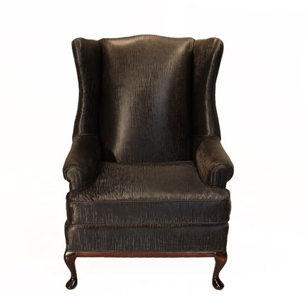 Oversized wingback chair with sharkskin vinyl upholstery with piping details. The base, with cabriole legs in front and curved back legs, is finished with a Walnut stain.

Seat depth measures 20.5