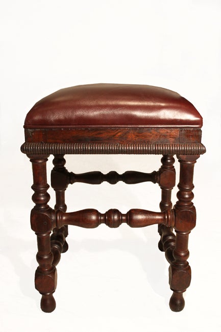 Pair of sculptural stools with ornately carved bases and banding. The seats have been upholstered in a wine shade of leather. We believe these stools to be Jacaranda de Bahia wood and are from the Dom Pedro era.
Many pieces are stored in our