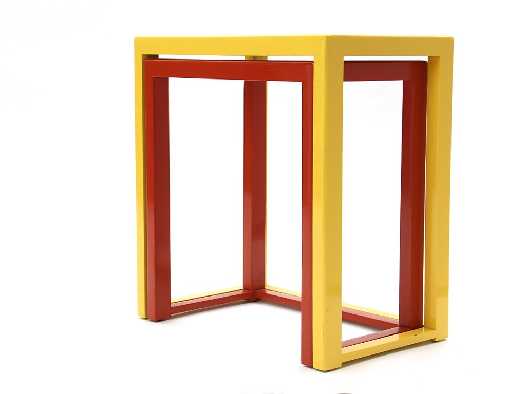A red-orange and yellow nesting table set in lacquered mahogany by Dunbar.