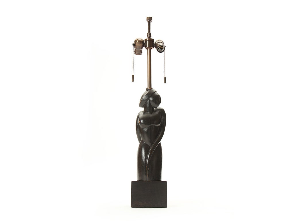A table lamp with a hand carved base in the form of a female nude. Base is 17
