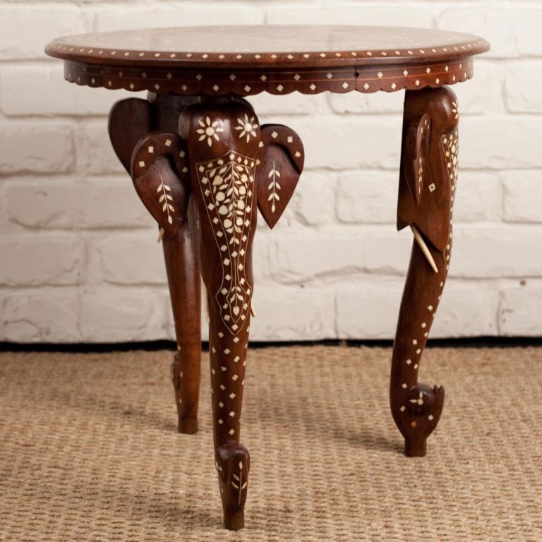 Anglo-Indian side table in solid rosewood with ivory and ebony inlay. Top inlay depicting scene with several elephants, legs carved in stylized elephant head design.