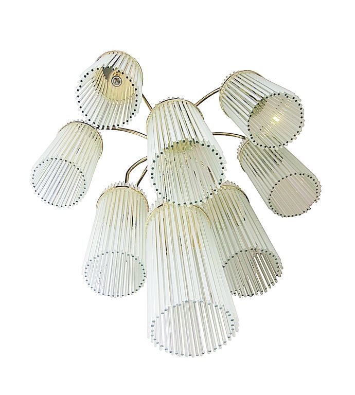 This lovely chandelier features<br />
848 glass rods on a 10 arms brass frame which creates a<br />
brilliant crystalline display.<br />
<br />
The chandelier is comprised of 10 arms and 11 light sockets, each arm has 80 long glass rods, 40