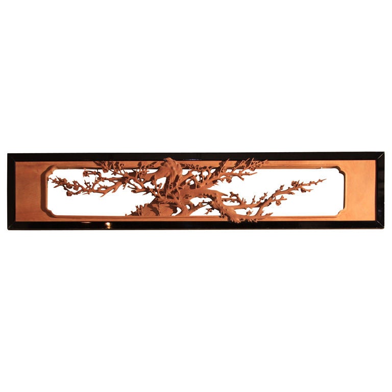 Japanese ranma (architectural transom) crafted of carved sugi (crypotomeria) wood surrounded by a black lacquered frame. The ranma depicting the trunk of a gnarled plum tree (ume).  The plum represents one of the 