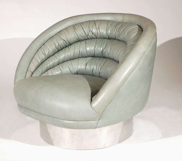 A Rare Channel Tufted Barrel Swivel Chair. USA, 1970s. An oversized channel tufted barrel back lounge chair. Chrome Swivel base.