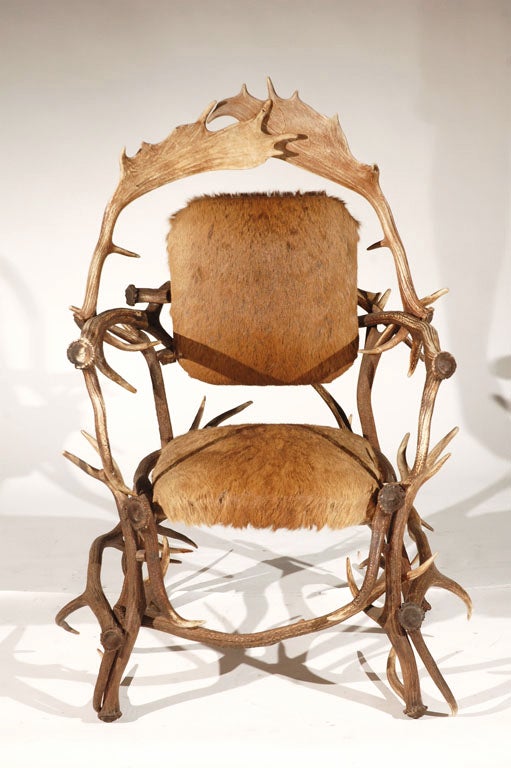 An Antler Armchair in Cowhide. USA, 1980s A hand crafted Deer Antler armchair upholstered in Cowhide. This arm chair is richly assembled out of deer antler and exhibits exquisite craftsmanship.