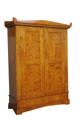 Biedermeier armoire of highly figured birch fitted with double doors with recessed panels over 2 short drawers, the whole raised on a graduated bracket base, original restored finish

In Central Europe, the Biedermeier era refers to the