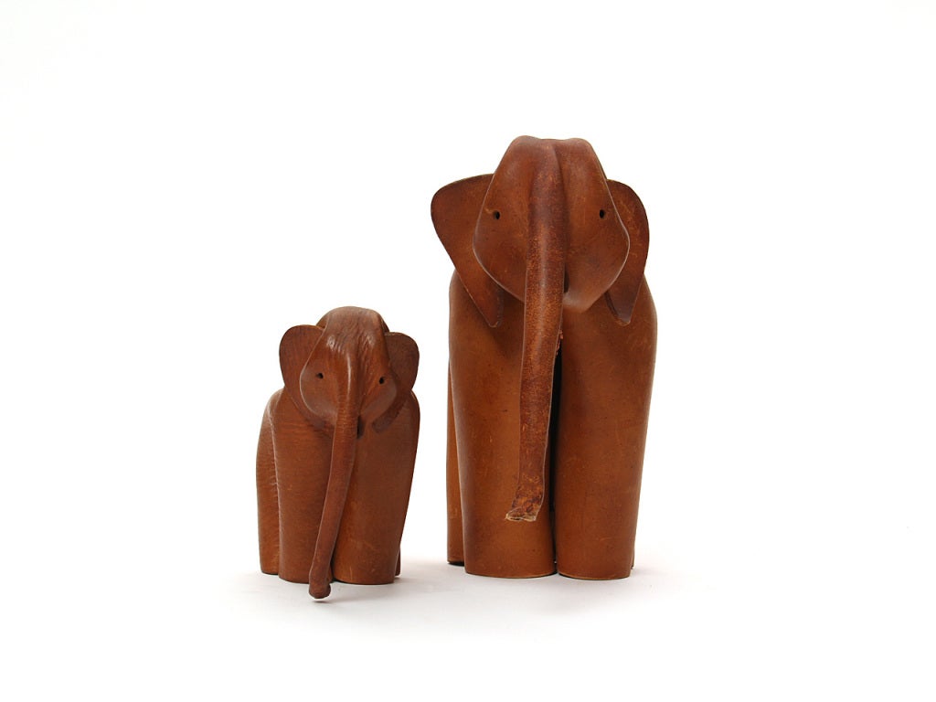 A pair of toy elephants made from pinching and riveting leather sheets.