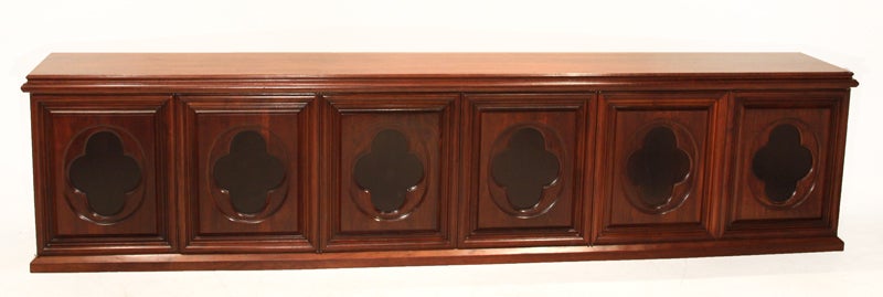 Solid walnut cabinet by Monteverdi-Young with ebonized inset clover motif. The six push hinge doors open to reveal a shelf in each compartment as well as pull-out drawers as seen in photos. This extremely long credenza spans over 10 feet.

Many