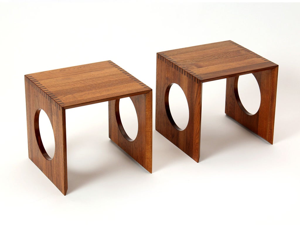 A solid teak pair of three sided interlocking nesting tables with large circle cut outs and box cut joinery which next to form a cube. Made by Richard Nissen, Denmark