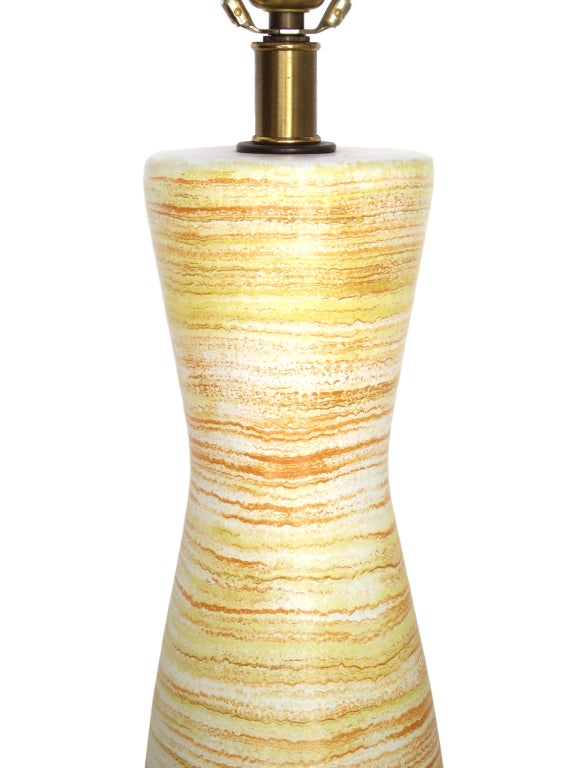 Ceramic table lamp by Design Technics in a cylindrical form with asymmetrically splayed ends, decorated in rippled layers of yellow, ivory, and terracotta and finished with a faint glaze.

*total height = 31 inches
* height of ceramic = 18 inches
*