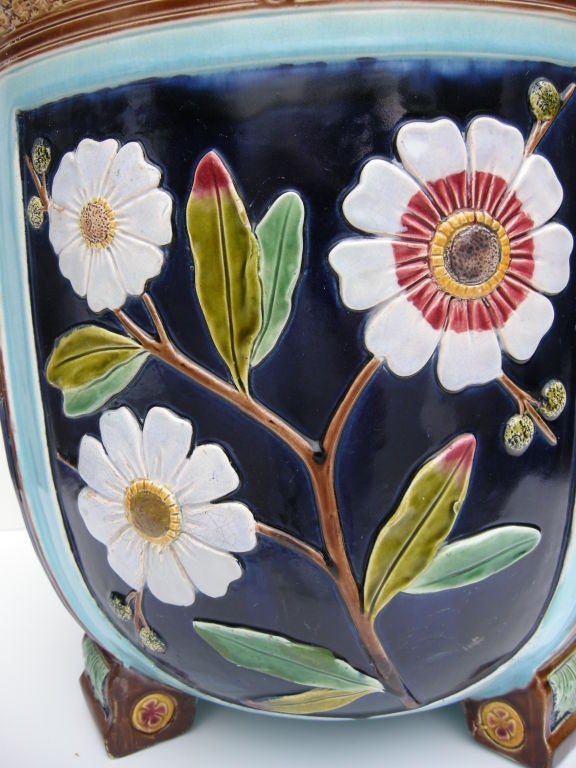 A 19th century  Wedgwood Majolica footed jardinière. Detailed paneled sides alternating with blossoming branches and florets. Colors of deep cobalt and aqua blues, reds and greens, truly an impressive piece.
Purchased from Narworth Castle Antiques