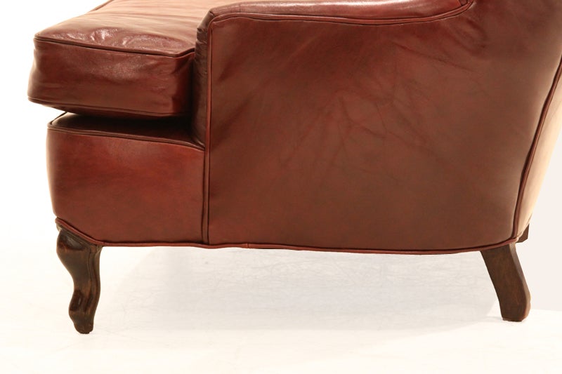 American Obtuse oxblood leather and Walnut wing back chair For Sale
