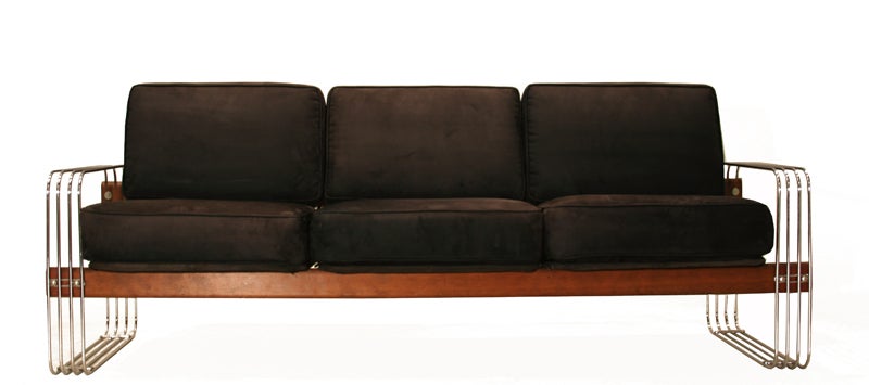 Stendig chrome and redwood sofa with soft black ultra-suede cushions. The sofa features Stendig's signature curved chrome rod sides and wood frame. The sofa was recently reupholstered.

Seat depth measures 20
