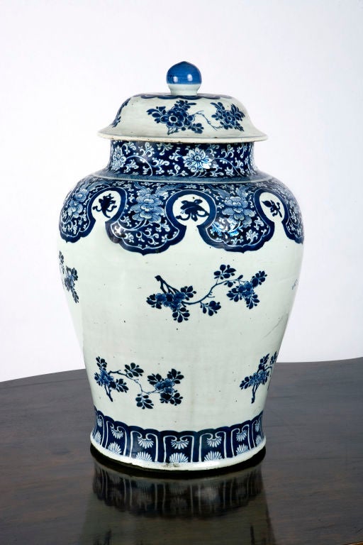 Large Chien Lung blue and white temple jar with floral decoration and peach of immortality on white ground.