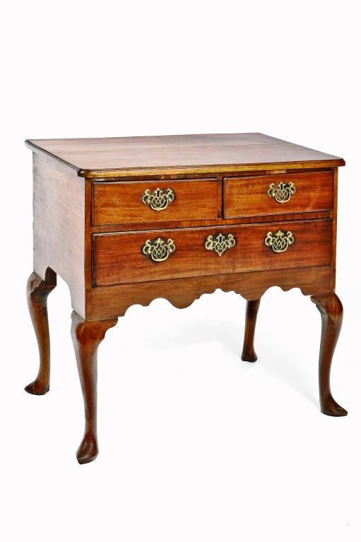 Georgian mahogany low boy with cabriole legs and slipper feet. Consisting of two short and one long drawer, with original pierced batwing brass handles and escutcheon.