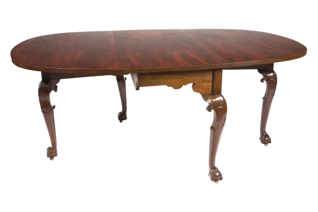 19th Century Irish Mahogany Drop Leaf Dining Table on cabriole legs, carved shells on knees, ending in ball and claw feet with brass casters.
