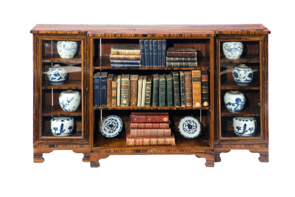 English Regency coromandel bookcase with open front, flanked by glazed doors.