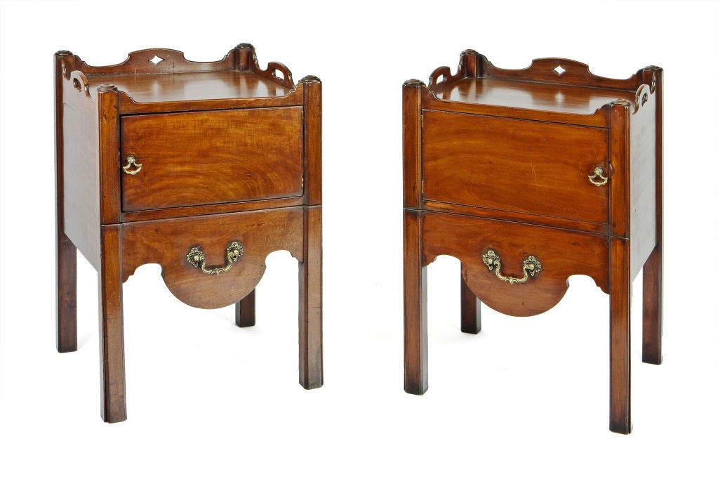 The rectangular top with three quarter gallery pierced with carrying handles above a panel door with a shaped lower sliding drawer revealing an adapted commode raised on square champhored legs.