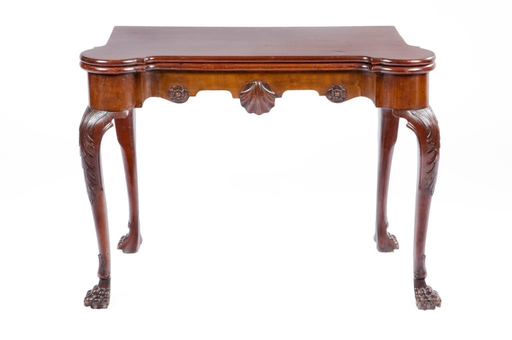 18th century Irish mahogany card table with carved acanthus leaves on knees and carved scalloped shell on frieze.