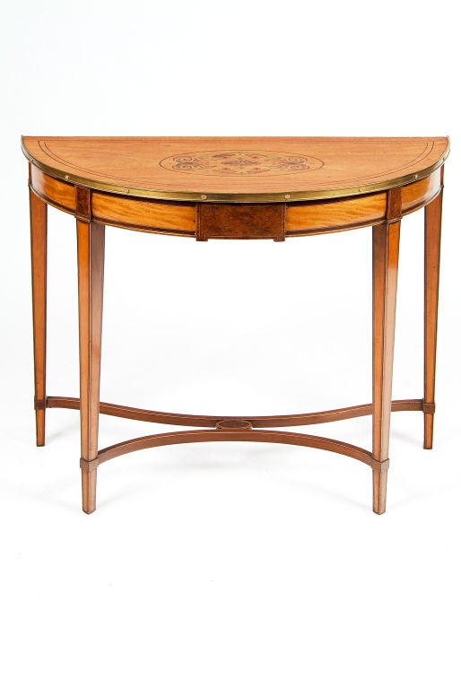 Satinwood Demilune Console Table. Its top inlaid, painted, and bound with a brass band.
