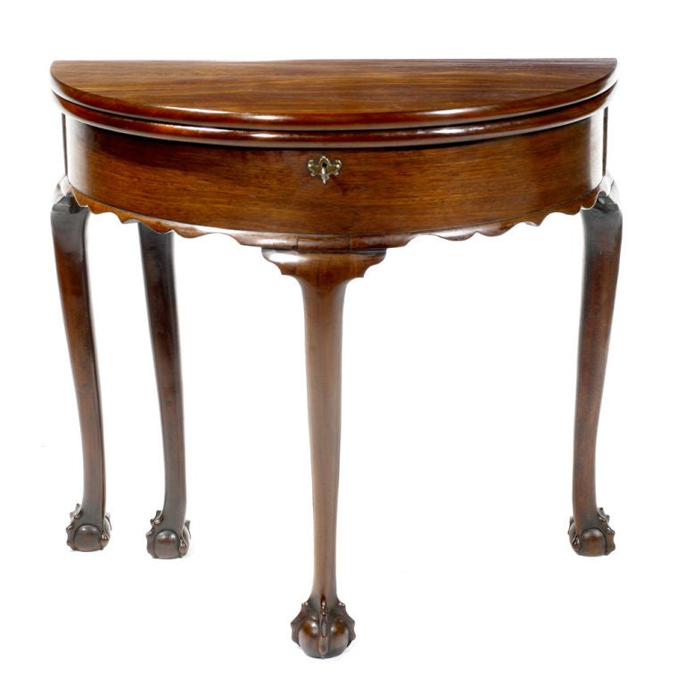 18th Century Irish Mahogany demilune card table with plain frieze and keyhole above apron plain cabriole legs and claw and ball feet.