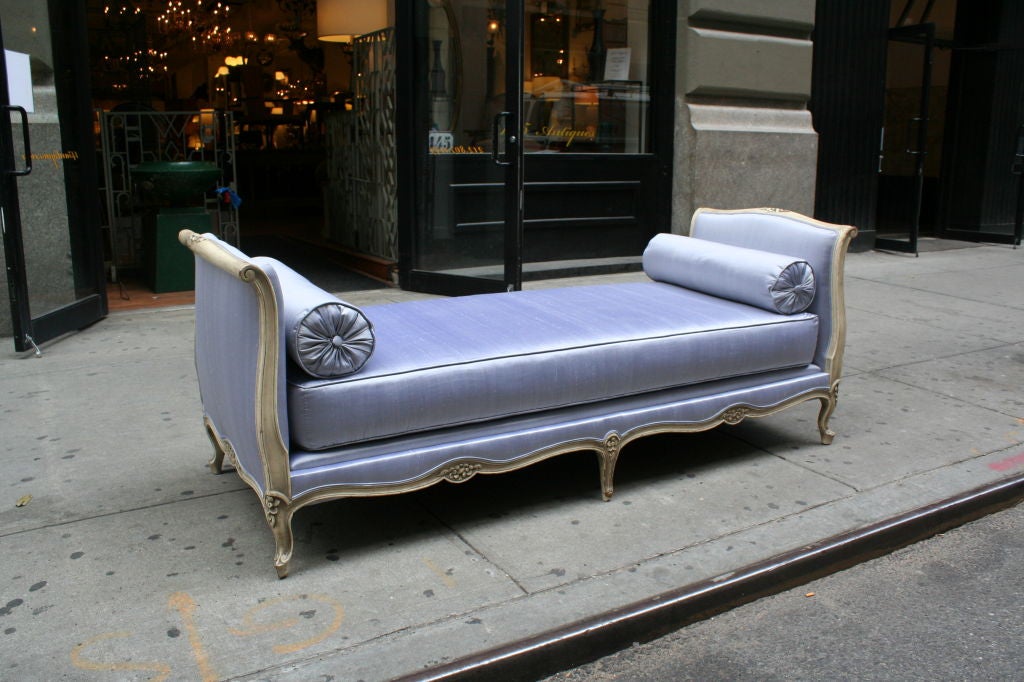 Large daybed in painted creme finish and upholstered in pale lavender  silk.
