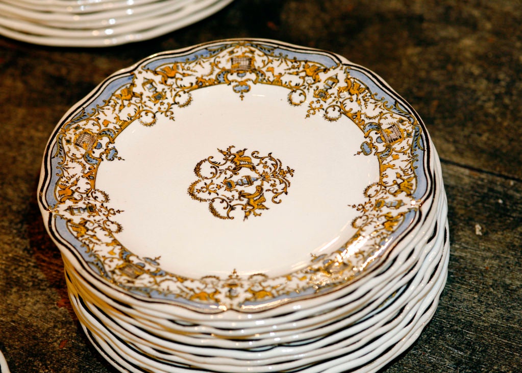 The classic French blue and yellow Dionysus pattern is one of Gien's trademark designs. This antique faience service includes: 12 dinner plates, 12 salad plates, 12 soup bowls, Covered Soup Tureen, Covered Vegetable Casserole, Footed Compote, Salad
