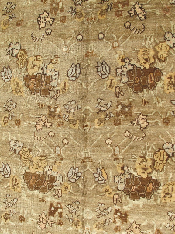 This piece features an all-over floral design complemented by a solid brown border and colors of brown, yellow, light blue, raffia, camel and ivory. Measures: 8'2 x 10'