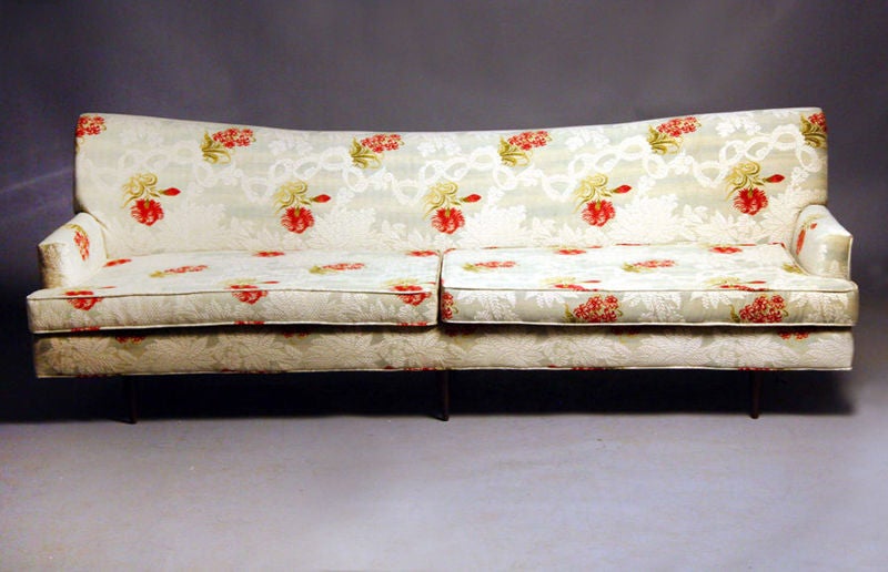 Upholstered sofa on tapered wood legs.