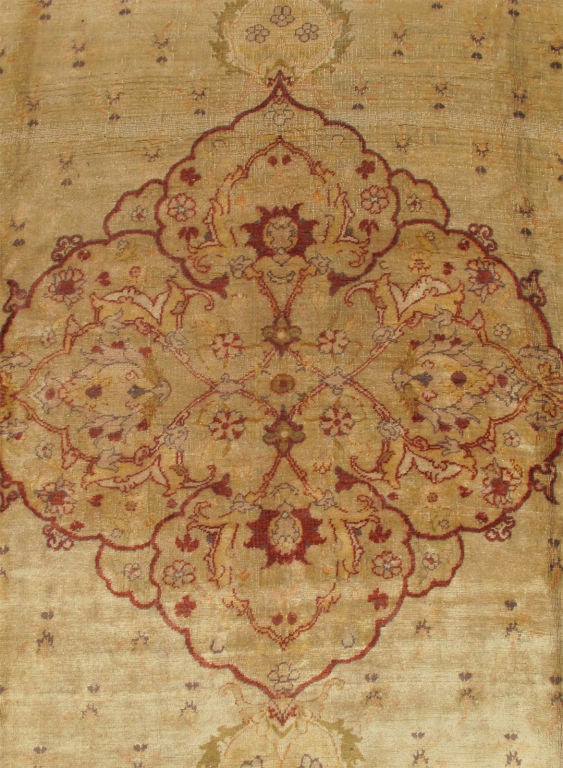 This impressive Oushak carpet fashioned during the turn of the century, possesses an incredibly sophisticated palette paired with delicately understated design.  A sumptuous Light Mocha forms the overall base color of the rug.  A refined Medallion