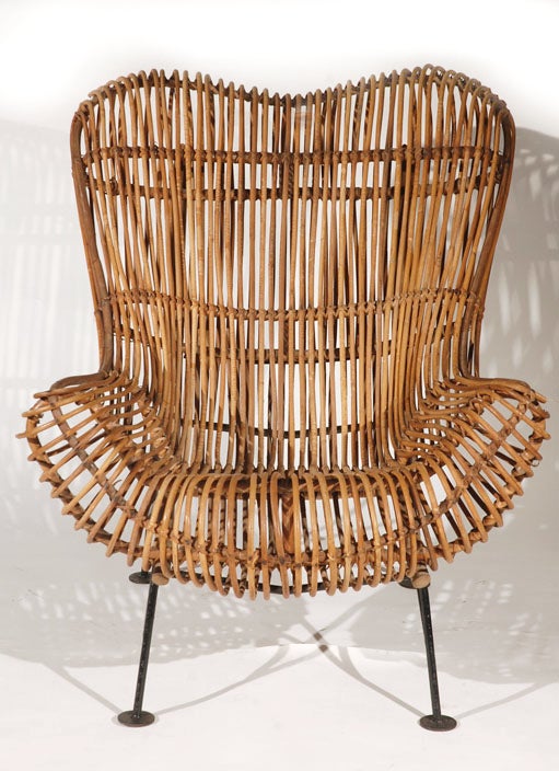 A rattan lounge chair in the style of Franco Albini's 